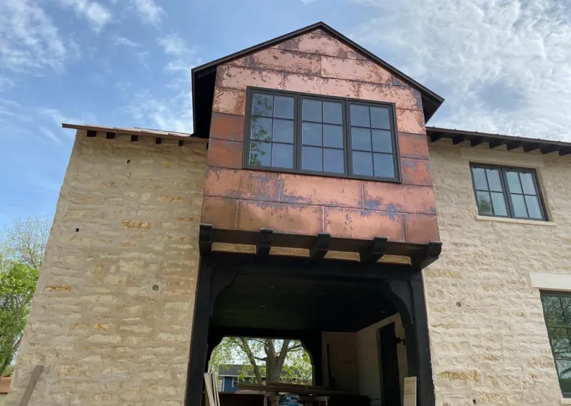 Copper metal panel facade on a stone building for Roof Repair in Mahtomedi